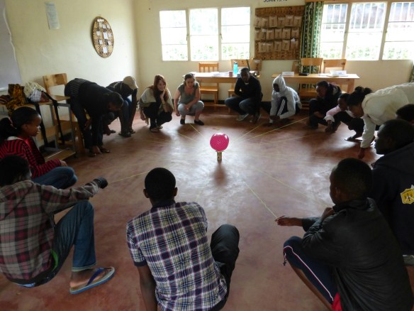 Working together to accomplish a challenge (getting the ball to a certain point without letting it fall)